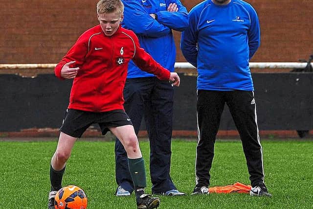 A youngster goes through his paces under the watchful eye of Staunton.