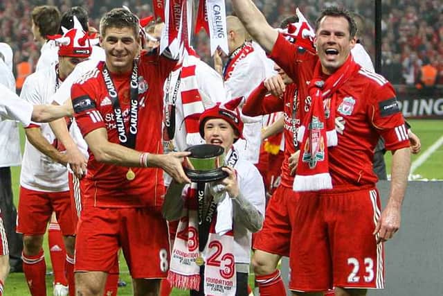 2012: Liverpool's Jamie Carragher and Steven Gerrard celebrate with the Carling Cup trophy