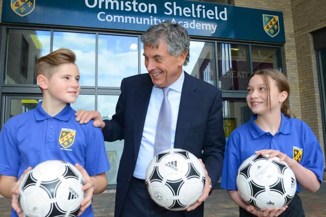 WALSALL COPYRIGHT EXPRESS&STAR TIM THURSFIELD 27/02/15 Former Arsenal chairman David Dein visits Shelfield Academy, Pelsall. Pictured with pupils Ben Watt, aged 12 and Chloe Dolan, aged 11. . (10199649)