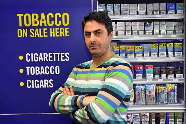 Store manager Masih Usufzai says he is losing money because of the illicit trade