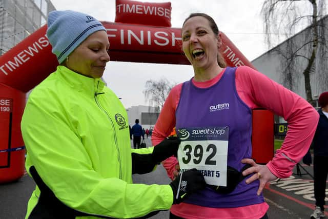 Gwen Jones, left, helps Nikki Wilkinson with her race number