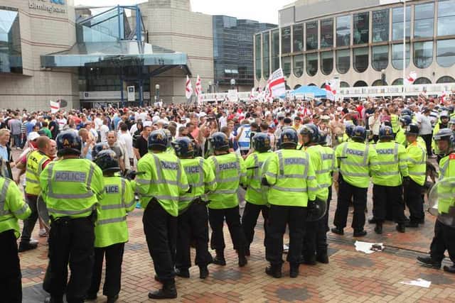 Police watch over a crowd on the day of the protest