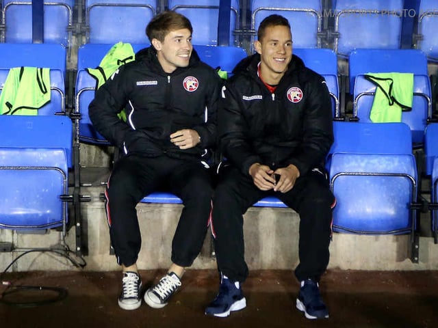 Former Shrewsbury player Tom Bradshaw of Walsall (L) sits on the bench at his former club earlier this season.