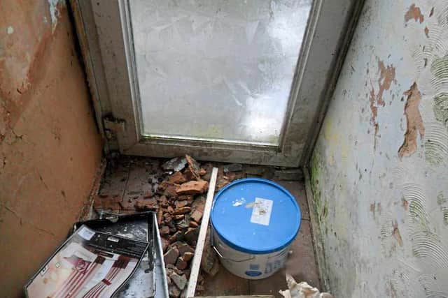 Bad plasterwork and loose bricks seen inside the property
