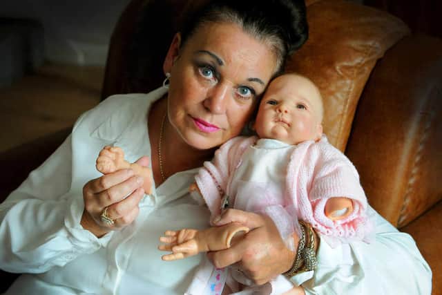Jane Dunn, pictured holding Susan's life doll, says her sister Susan Hearsey, was abused and bullied at Walsall Manor Hospital by staff nurses.