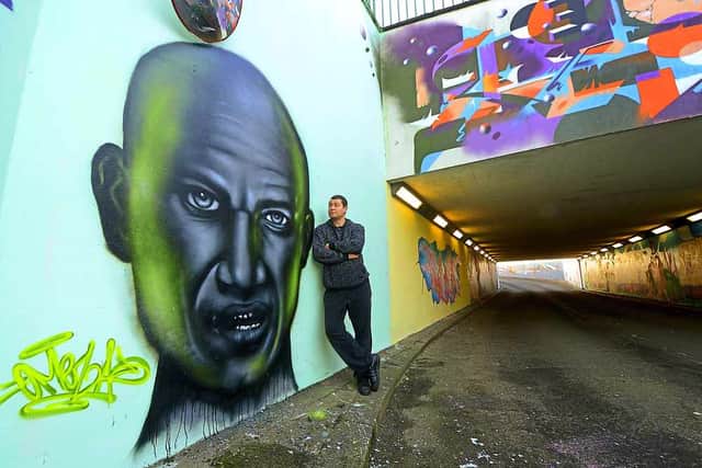 Paul Pilgrim next to another impressive graffti portrait of star Goldie
