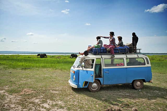 Adventure – Rachel and the team looking at elephants at Murchison Falls National Park on top of their trusty VW camper van