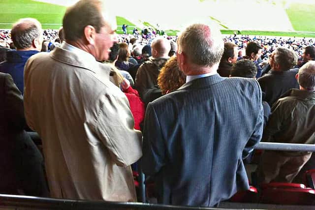 Steve Morgan watches the game with Sir Norman Bettison
