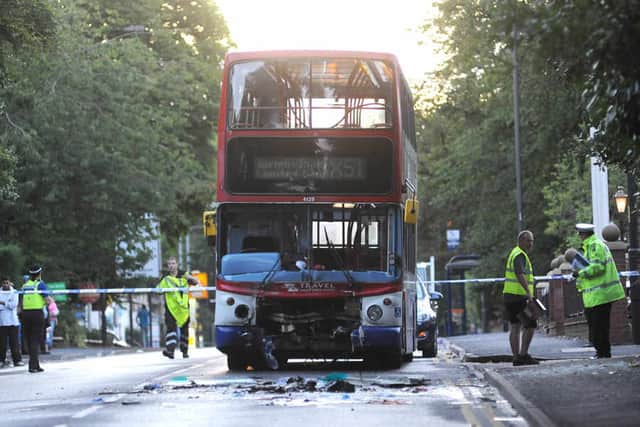 The badly-damaged bus and debris left scattered across the road after the crash