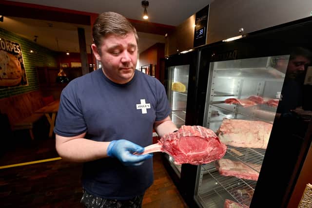 Matt Moulson with meat from Perrys of Eccleshall and a Dry Ager which displays the meat to the public so they can see it before they eat it