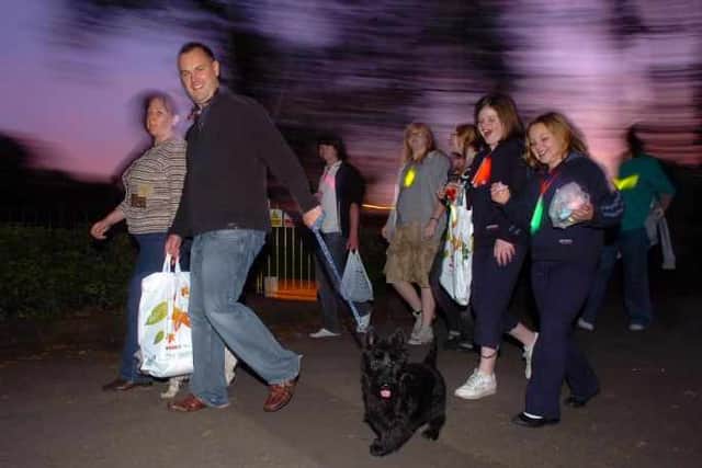 Friends, families, colleagues and even family pets donned glowing necklaces and waved torches to light the way around the park's lake last night.nextpage