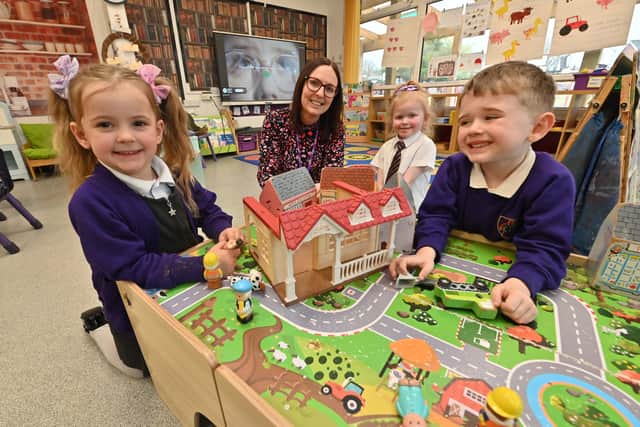 Deputy headteacher Sam Davidson in Early Years with Betty, Elorah and Charlie 