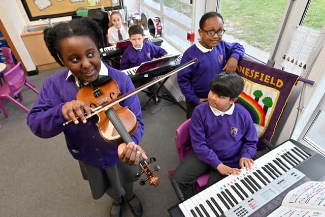 Elizabeth, Louisa, Jacob, Perkins and Aditya enjoy a music lesson