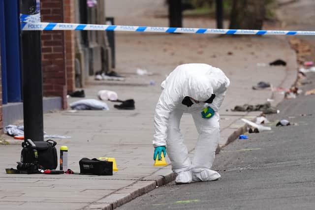 A forensic investigator at the scene in Friar Gate, Derby, where a number of people had been injured, some of them seriously, but not life-threatening, after being hit by a car in the city centre on Saturday night.