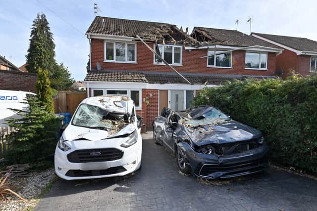 Two semi-detached houses and two vehicles were wrecked when the tree fell