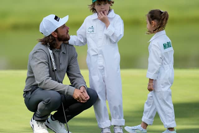 Tommy Fleetwood crouches down next to son Frankie