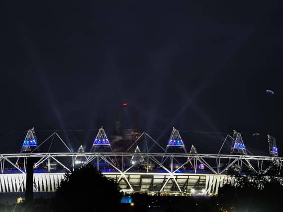 Parachutists drop into the Olympic Stadium