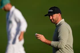 Wyndham Clark waves after his putt on the second hole