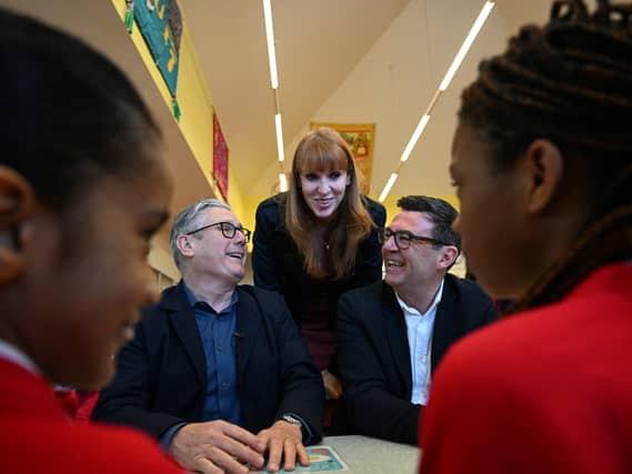 Keir Starmer, Angela Rayner and Andy Burnham share a joke during a visit to a school