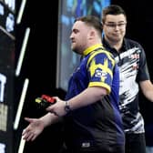 Netherlands’ Gian van Veen, right, reacts after shaking hands with Luke Littler in the Premier League in Manchester