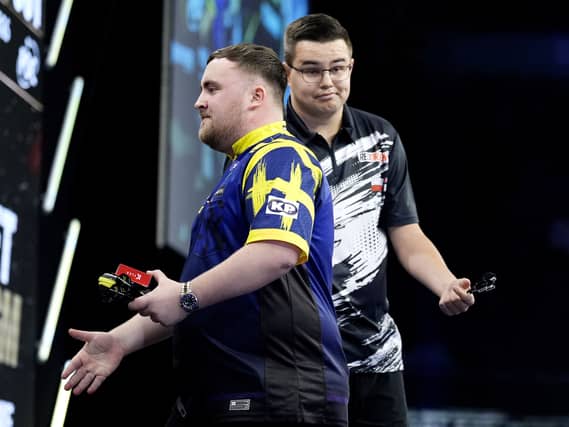 Netherlands’ Gian van Veen, right, reacts after shaking hands with Luke Littler in the Premier League in Manchester