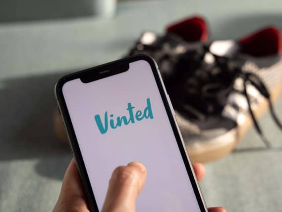 Person with thumb on the Vinted app