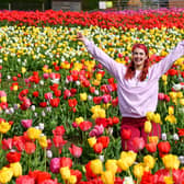 Staff member Marley Dowding enjoys the flowers at Lower Drayton Farm