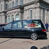 The hearse arrived with members of Hubert's family following behind