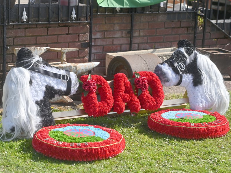 Pictured are funeral flowers outside his home, and traditional Romany Travelling homes he made