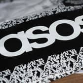 An ASOS delivery package resting on the floor along with letters received in the mail.