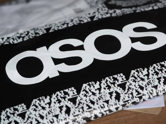 An ASOS delivery package resting on the floor along with letters received in the mail.