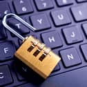An unlocked padlock on computer keyboard
