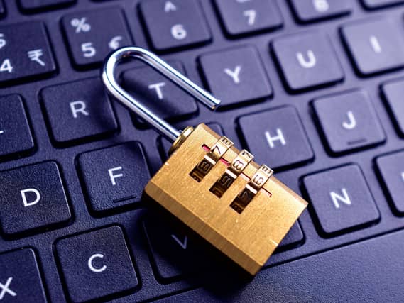 An unlocked padlock on computer keyboard