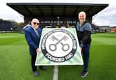 Stamp artist Pete Mason has made a replica of the Hednesford Town FC badge using stamps. He is pictured presenting it to chairman Craig Gwilt at the club just hours before the club play in the play-offs.