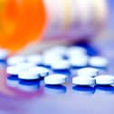 Pills lying beside a bottle