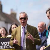 Nigel Farage speaking while campaigning on a street