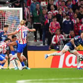 A shot from Atletico Madrid’s Marcos Llorente hits the hand of Arsenal’s Ben White