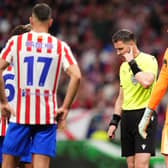 Referee Danny Makkelie consults VAR before overturning his decision to award Arsenal a second penalty against Atletico Madrid