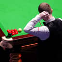 Mark Allen scratches his head as he inspects a cluster of reds and the black over the corner pocket during frame 14 against Wu Yize