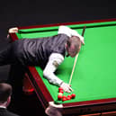 Mark Allen pots the black and fouls through a cluster of reds