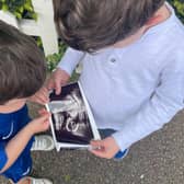August and Ernest Brooksbank looking at scan of the baby