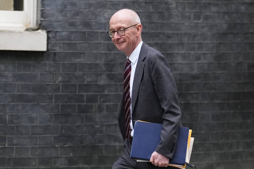 Pat McFadden smiling while walking on Downing Street