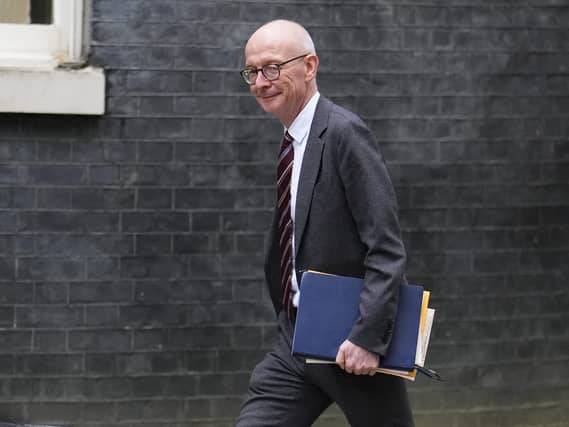 Pat McFadden smiling while walking on Downing Street