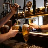 A barman pouring drinks