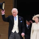 The King raising his top hat