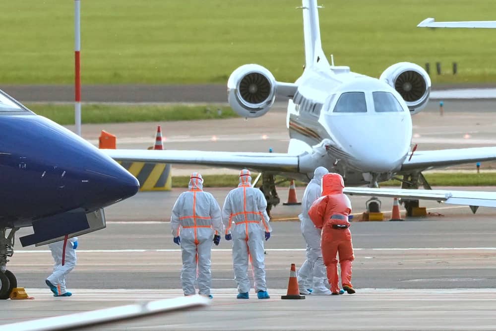 Medics escort a patient, second right, evacuated from the MV Hondius cruise ship with suspected hantavirus infection, to an ambulance after being flown to Schiphol airport, Amsterdam, Netherlands