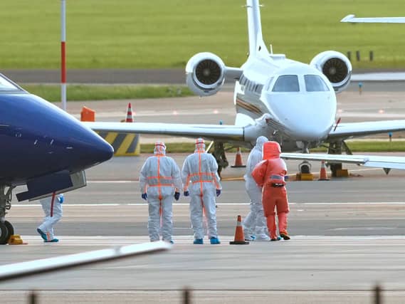 Medics escort a patient, second right, evacuated from the MV Hondius cruise ship with suspected hantavirus infection, to an ambulance after being flown to Schiphol airport, Amsterdam, Netherlands