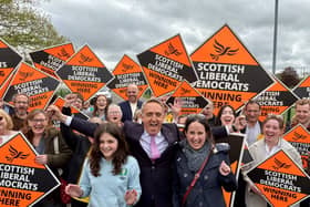 Alex Cole-Hamilton with his wife Gill and daughter Darcy surrounded by supporters