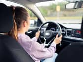 A young woman driving a car