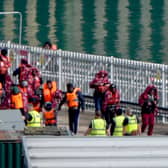 A group of people thought to be migrants are brought in to the Border Force compound in Dover
